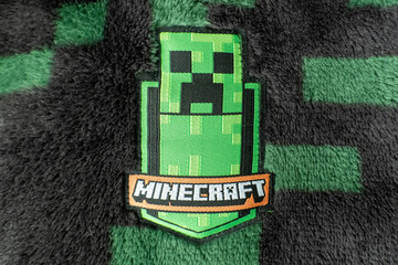 Naklejka premium A Minecraft creeper fabric badge on black and green creeper fleece material. Bradford, UK Oct 2 2026