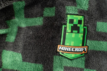Naklejka premium A Minecraft creeper fabric badge on black and green creeper fleece material. Bradford, UK Oct 2 2026