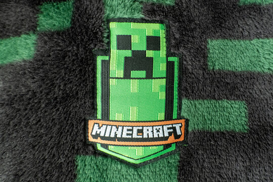 A Minecraft creeper fabric badge on black and green creeper fleece material. Bradford, UK Oct 2 2026