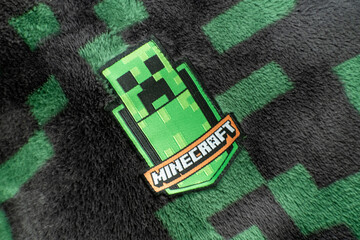 Naklejka premium A Minecraft creeper fabric badge on black and green creeper fleece material. Bradford, UK Oct 2 2026