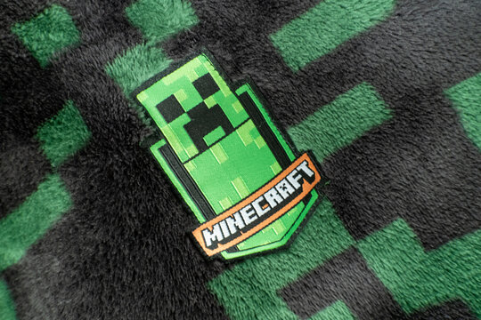 A Minecraft creeper fabric badge on black and green creeper fleece material. Bradford, UK Oct 2 2026