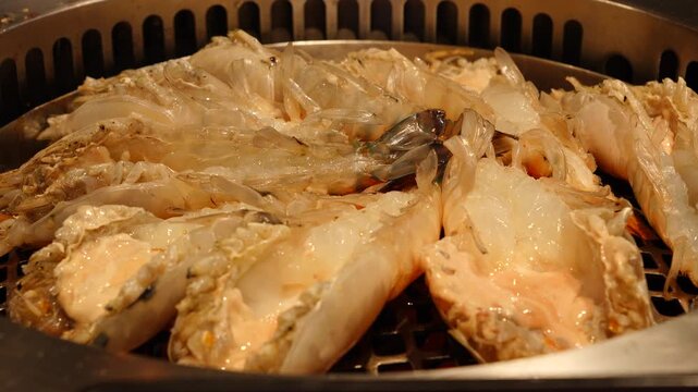 Time lapse people are eating sea food. Grill shrimps barbecue on hot coal in the restaurant. VDO 4k close up the cooked grill shrimps