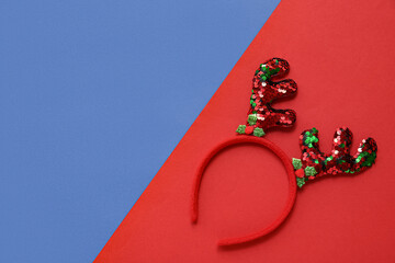 Christmas reindeer antlers headband on color background © Pixel-Shot