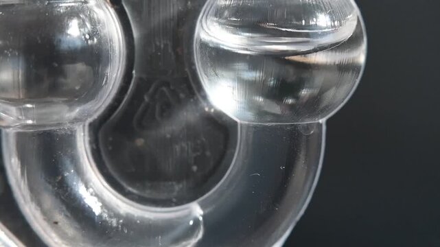 Fermentation lock used in alcohol production. Release of carbon dioxide, bubbling.
