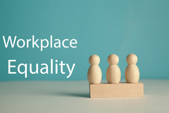 Wooden figures of people stand on a pedestal with the inscription workplace efficiency.