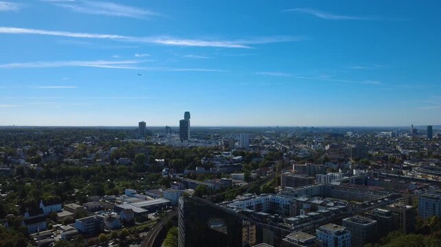 Passenger airplane approaching Frankfurt during descent, seen above the city and Henninger Tower in Sachsenhausen. Filmed September 25, 2026.