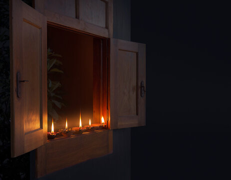 Night window with a short row of diyas, Diwali interior seen from outside