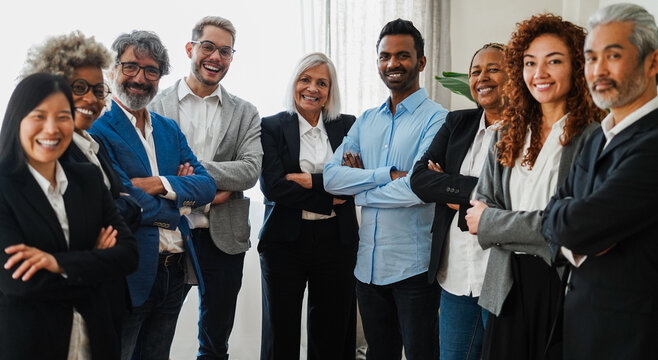 Multigenerational business people smiling on camera inside bank office - Corporate and financial meeting concept - Main focus on indian man face - UGC content