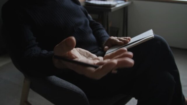 Middle aged Caucasian therapist gesticulating with pen while holding notebook in consultation. Suitable for mental health services, psychological therapy, and medical campaigns