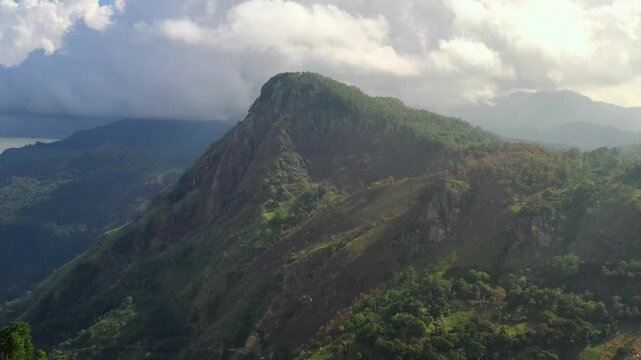Aerial View of a Lush Green Mountain Peak in Sri Lanka Under Cloudy Sk