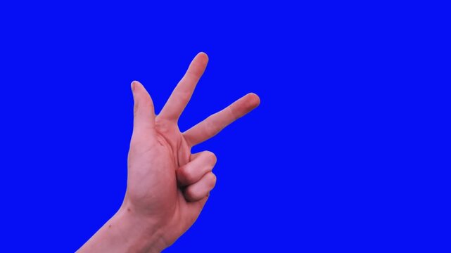 Person counting from one to five using hand gestures against a bright blue screen background for composite video editing