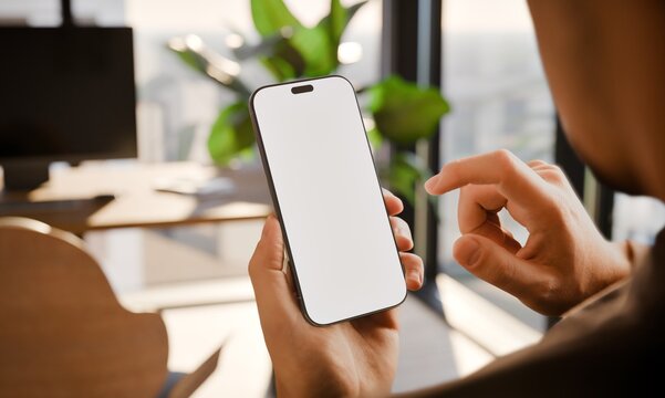 Smartphone Blank Screen Mockup in Hand, Over-the-Shoulder View in Modern Office