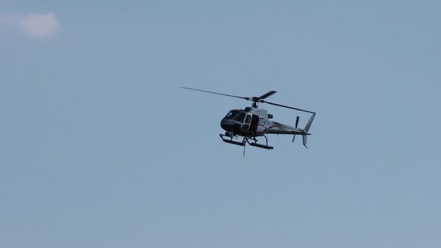 Video clip of a broadcast helicopter flying in the sky.