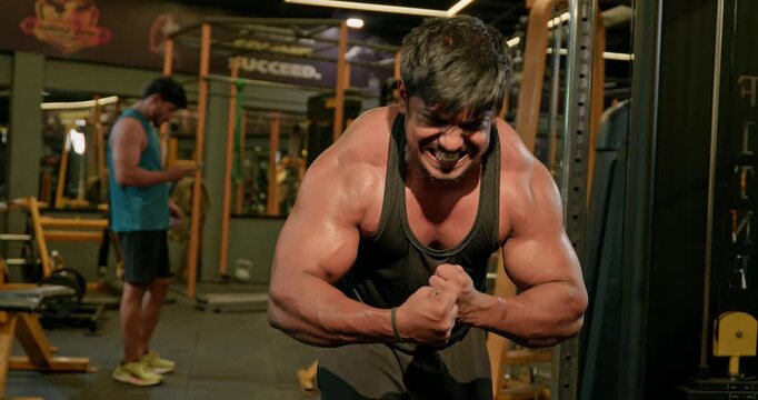 Muscular Bodybuilder Training Triceps With Weights During Gym Workout &mdash; Focused athlete completes multiple triceps repetitions with controlled movements, showcasing defined arms, strength development 