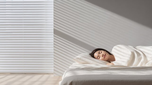 Serene morning light and shadows on a peacefully resting woman in a cozy bedroom