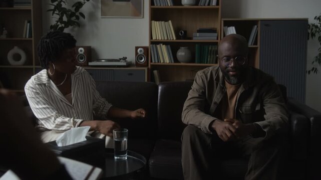 African American couple discussing emotional issues in therapy session. Footage suits mental health campaigns, relationship coaching ads and psychological services