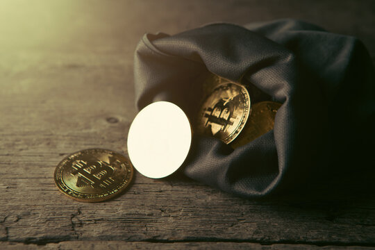 A sack of Bitcoin on a wooden background.
