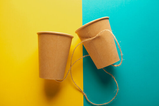 paper cups on color background