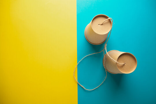 paper cups on color background