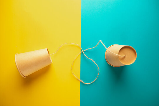 paper cups on color background