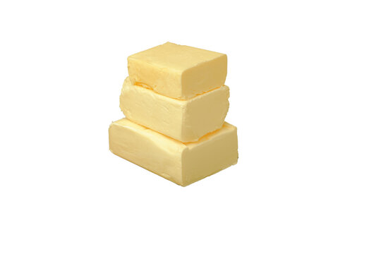 Butter stacked in three pieces on a plain white background
