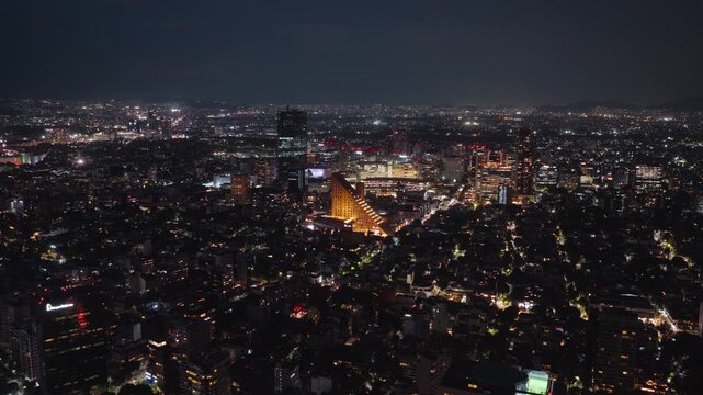 Aerial view of Polanco district illuminated at night with skyscrapers and urban lights in Mexico City, Mexico.