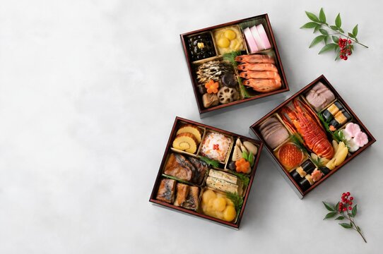 三つの重箱に詰めた彩り豊かなおせち料理 俯瞰撮影の余白あり背景