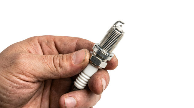 A hand holding a spark plug, a crucial car part, symbolizing auto repair and maintenance.