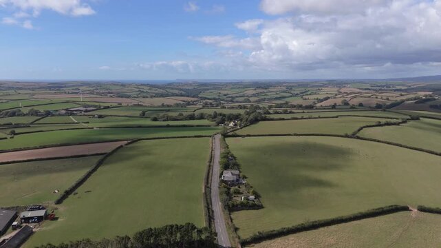 Aerial view of the rolling green fields and hedgerows of the rural landscape in Lanreath near Looe, England, United Kingdom.