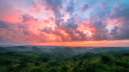 Obraz premium Stunning landscape view of rolling green hills during a dramatic golden hour sunset with vibrant colorful clouds