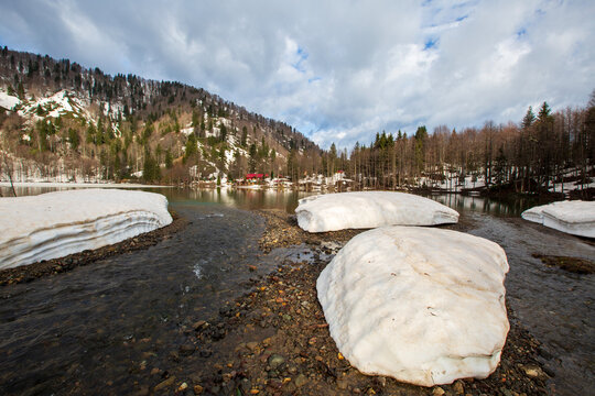 cenic view of snow melting at Bor&ccedil;ka Karag&ouml;l Nature Park with mountain reflections in spring, Artvin, Turkey.