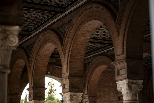 View of the ornate brick arches and marble columns at Plaza de Espana in Sevilla, Andalucia, Spain.