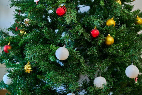 Closeup of decorations on a Christmas tree during the holiday season.