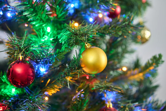 Christmas, empty and decoration on tree in home for festive tradition, holiday season and celebration. December, space and closeup of bauble, ornament and balls for xmas, vacation and aesthetic