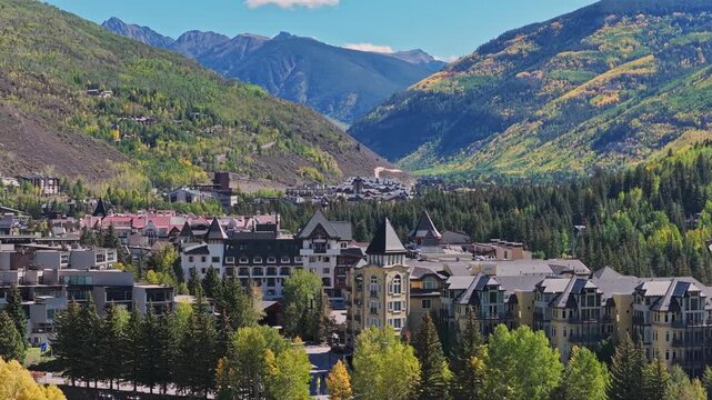 Aerial view of the mountain resort town of Vail nestled in the valley with lush forests and alpine architecture in Vail, Colorado, United States.