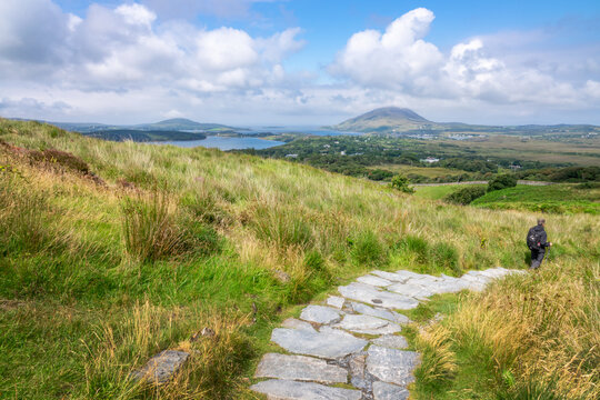 Hiker in the Connemara National Park, scenic view from the Diamond Hill trail, County Galway, Ireland