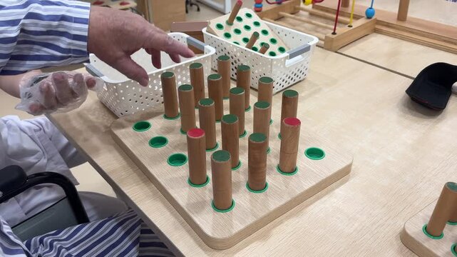 Stroke rehabilitation hand exercise with wooden peg board