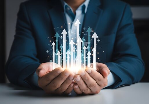Businessman in a suit holding cupped hands with glowing upward financial growth arrows concept