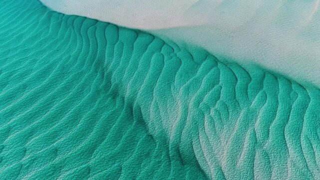 Aerial view of sand ripples in turquoise coastal waters at Amity Point, Queensland, Australia.