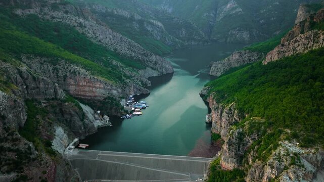 Aerial approach to Drini River reservoir dam in Albania at sunset