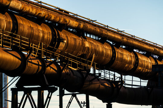 View of large rusty industrial pipes and structural supports at the historic industrial site in Ostrava, Moravian-Silesian Reg, Czechia.