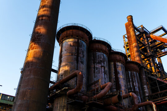 View of the historic industrial blast furnace structures with towering chimneys and complex piping at the Dolni Vitkovice complex in Ostrava, Moravian-Silesian Reg, Czechia.