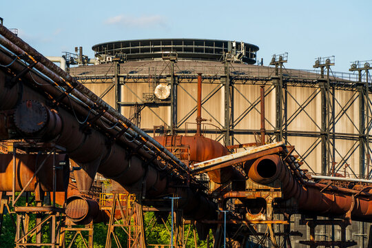 View of the industrial architecture at Dolni Vitkovice with rusty pipes and a large gasholder in Ostrava, Moravian-Silesian Reg, Czechia.
