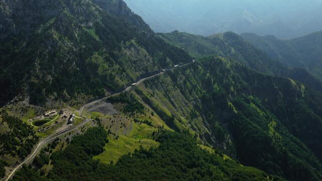 Rising Aerial Reveal of Forested Mountain Road in Shale Albania