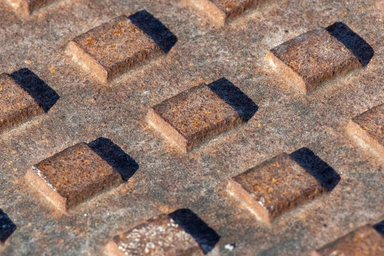 Rusty metal manhole cover pattern with textured surface