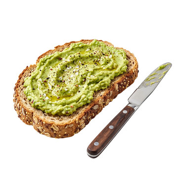 A slice of whole grain bread topped with creamy mashed avocado, seasoned with salt, pepper, and olive oil, accompanied by a butter knife isolated on transparent background