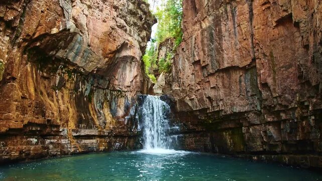 Closeup view of Cascade Creek Falls cascading through rugged canyon walls at dusk near the Million Dollar Highway in Colorado