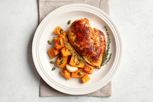 Autumn meal: roasted chicken breast and pumpkin with herbs
