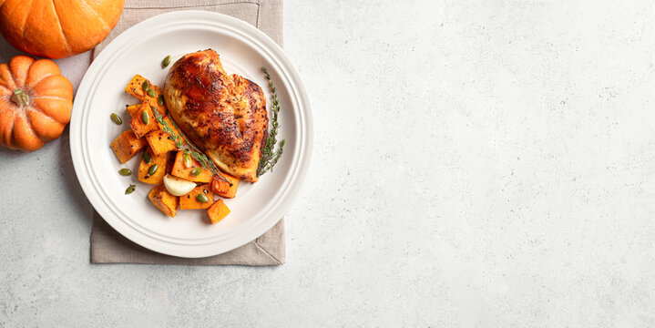 Autumn meal: roasted chicken breast and pumpkin with herbs