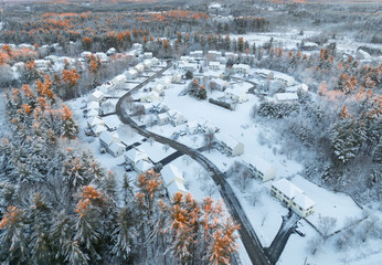 Obraz premium aerial view of residential community after snow storm under dusk sunlight